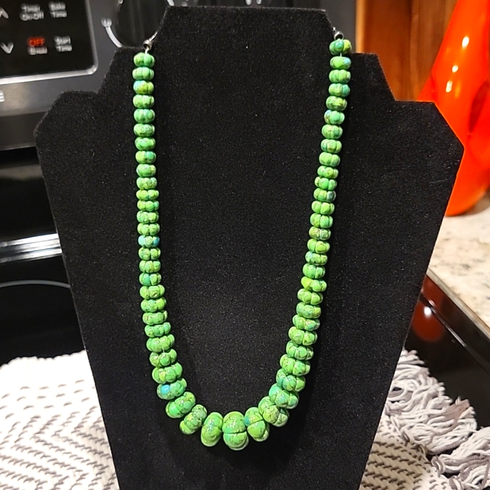 Necklace tapered green stones with small blue accents.